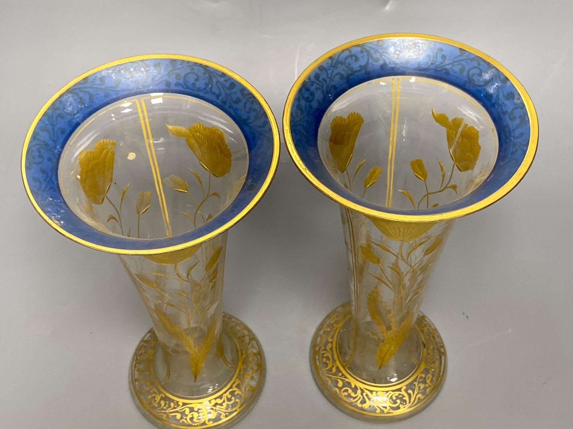 A pair of Bohemian gilt painted and blue flash cut trumpet shaped glass vases, 26cm